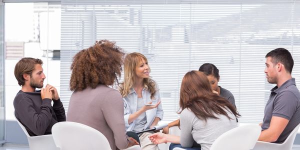 A group of people sitting around in a room.